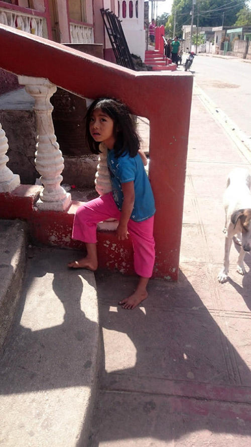 Child in a small village along the road