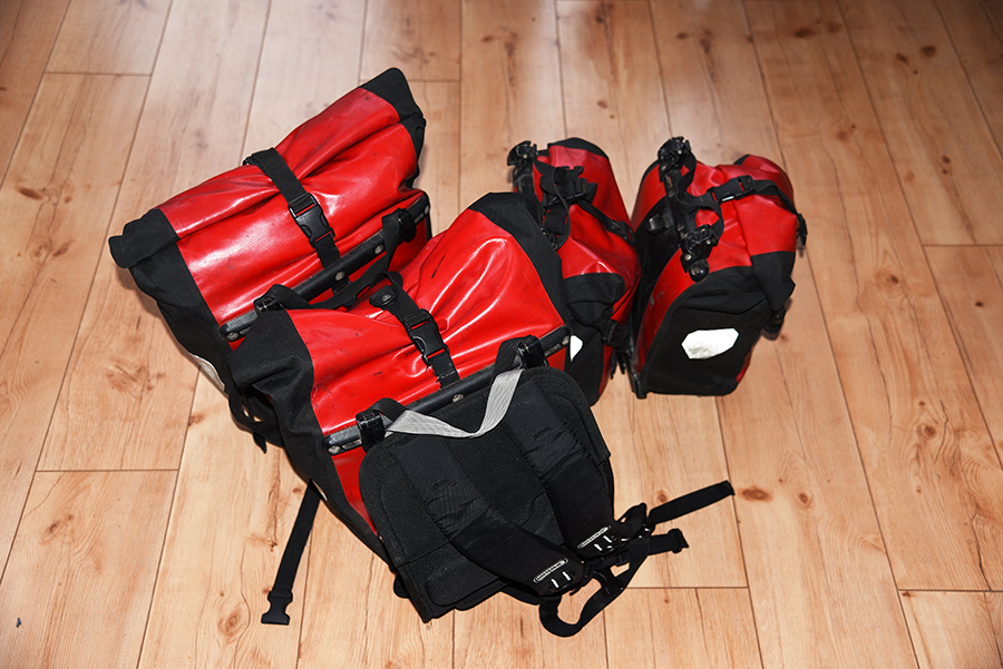 Four ortlieb panniers one used as a hand luggage